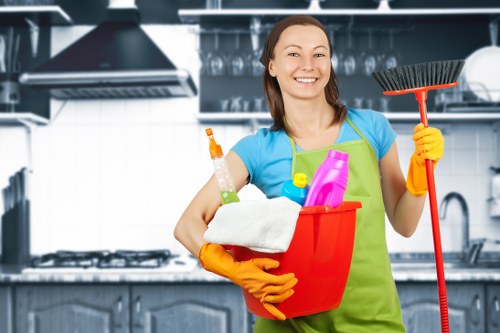 Cleaner preparing to dust and vacuum a family home in Islington